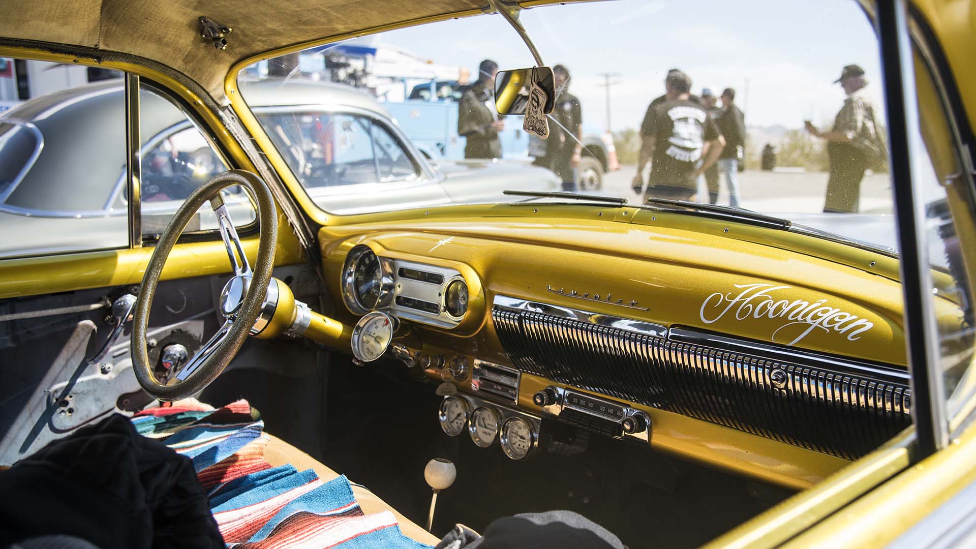 Classic hot rod enthusiasts take a break from driving old Route 66 in Ludlow, California.