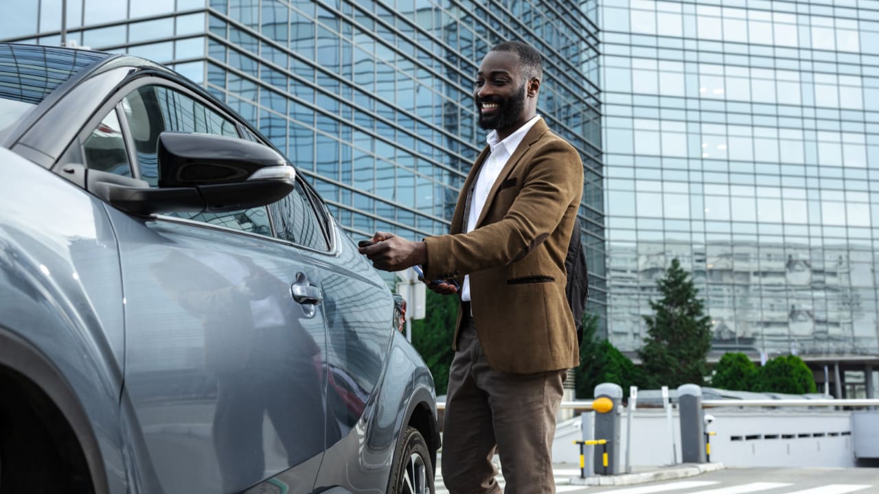 Business man getting into his car