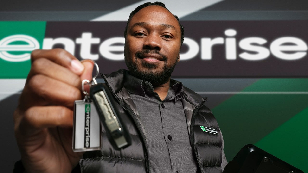 friendly enterprise employee hands over rental car keys