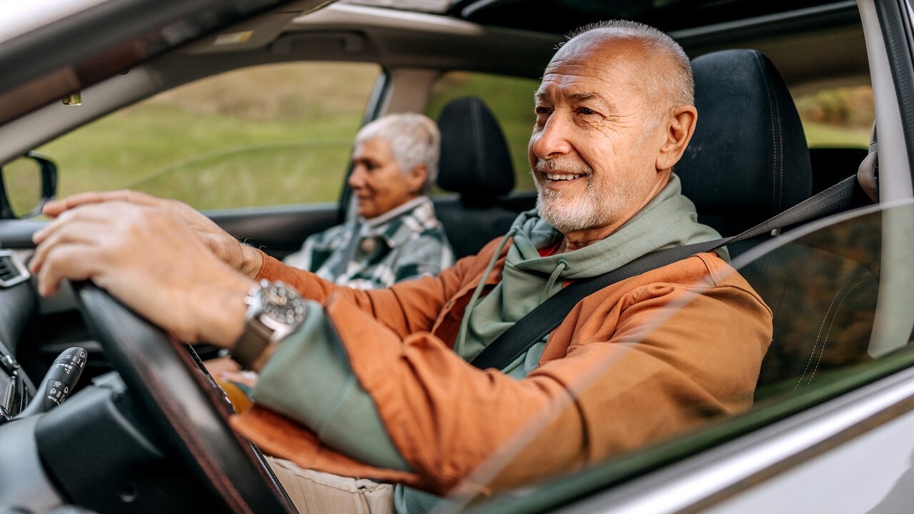 Senior couple on a road trip in a car together