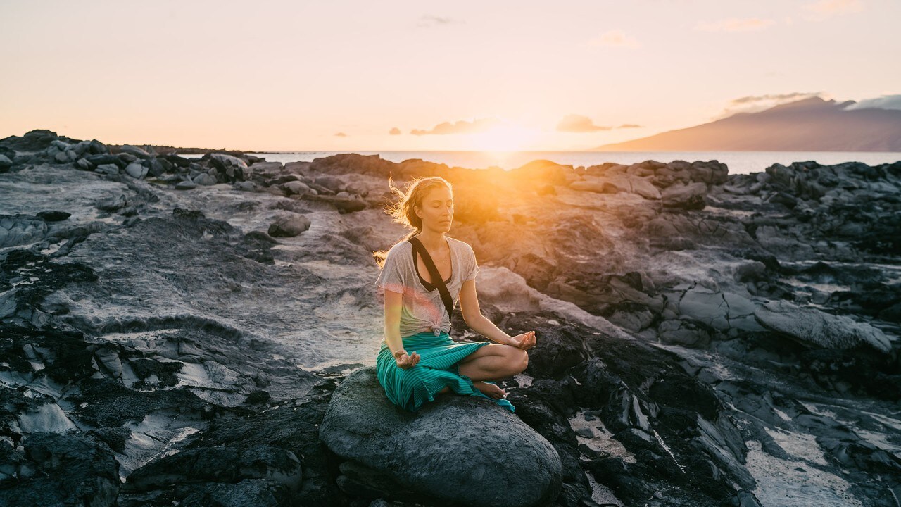 Sunset meditation on the volcanic rocks of Dragon's Teeth. Photo by Anthony Russo.