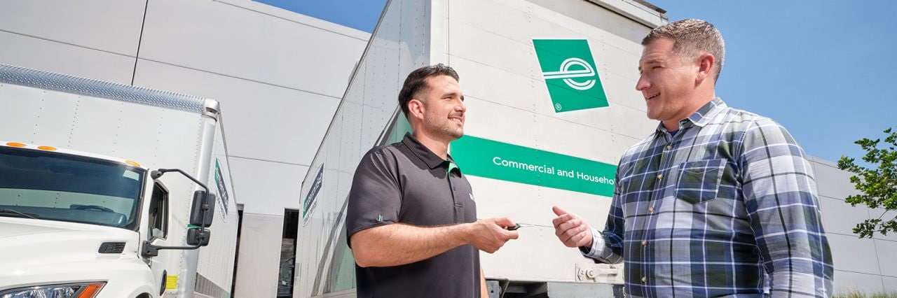 Man handing keys to box truck to customer.